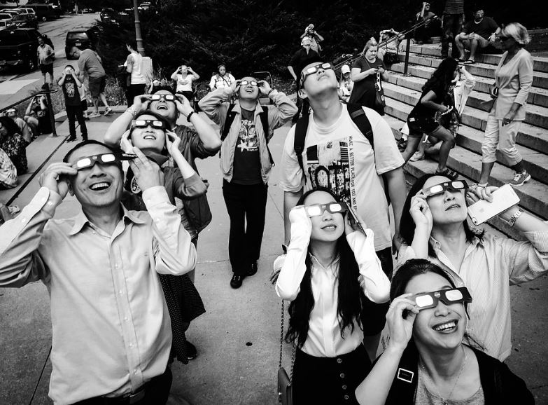people viewing a solar eclipse with eclipse glasses
